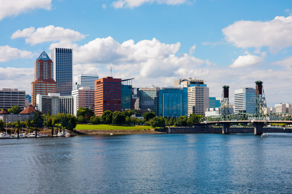 A picture of downtown Portland, Oregon across from the river on a sunny summer day.